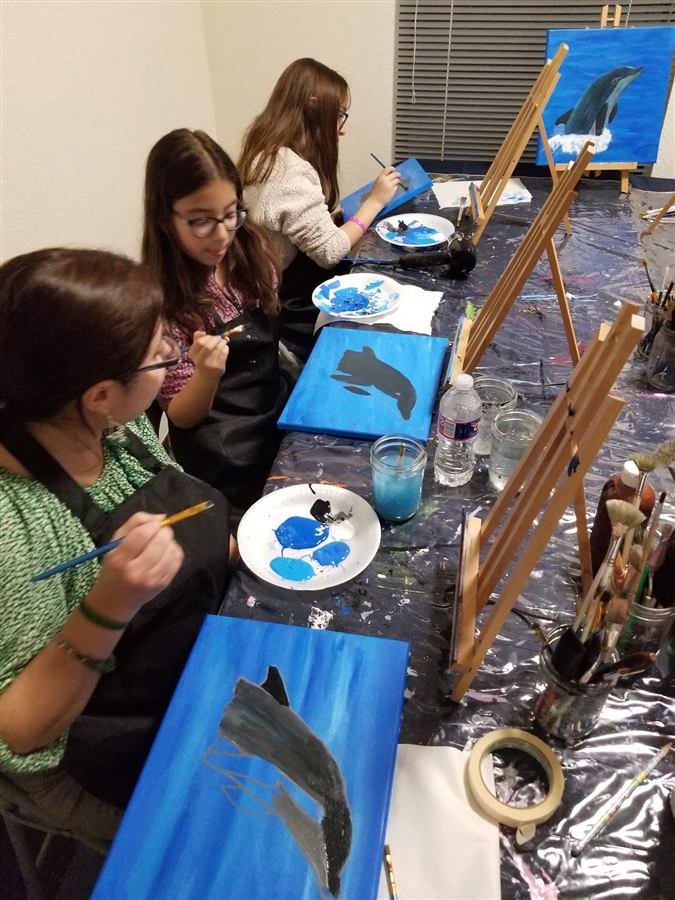 Students painting at one of Wilhelmina's classes