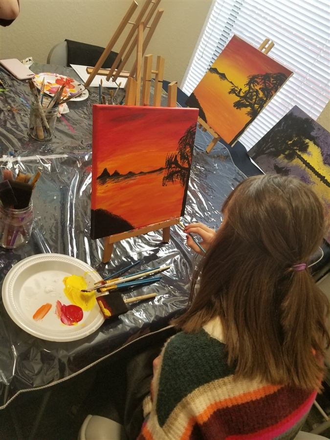 Students painting at one of Wilhelmina's classes
