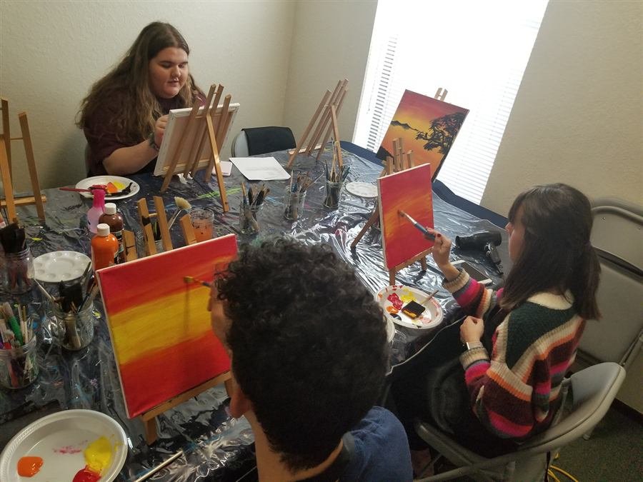 Students painting together at one of Wilhelmina's classes